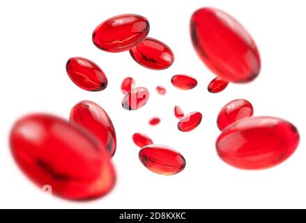 Red capsules levitate on a white background Stock Photo