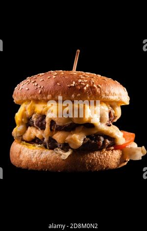 Burger isolated on black background. Stock Photo