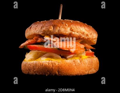 Burger isolated on black background. Stock Photo