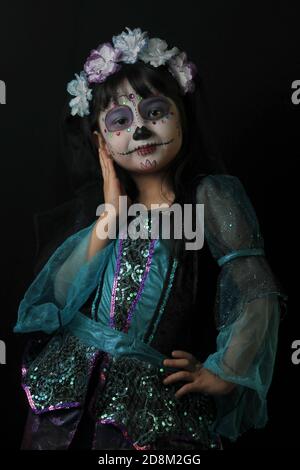 Mexico City, Mexico. 30th Oct, 2020. MEXICO CITY, MEXICO - OCTOBER 30: A girl eyes the camera, while posing with her face make-up as skull, to celebrate the Mexican Day of the Dead, the tradition of children asking for sweets from door to door, was suspended as precautionary to avoid new cases due the Covid-19 on October 30, 2020 in Mexico City, Mexico. Credit: Ricardo Castelan Cruz/Eyepix Group/The Photo Access Credit: The Photo Access/Alamy Live News Stock Photo