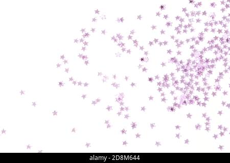 Pink sequins on a pink pastel background with confetti as asterisks. Stock Photo