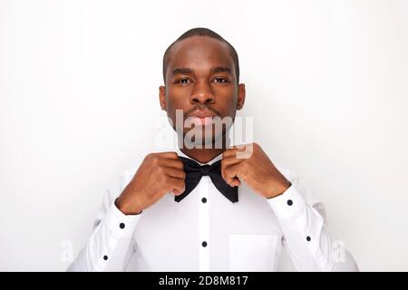 Close up portrait of cool african american man adjusting bowtie Stock Photo