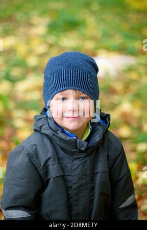 Cute little boy walking in the Park on an autumn day. Smiling Stock Photo