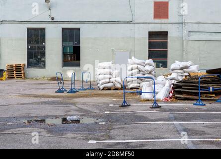 Bags of construction mix are scattered in the yard. Preparation for repairs Stock Photo