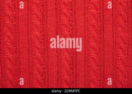 Real red knitted fabric with cable pattern textured background Stock Photo