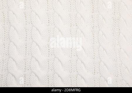 Real white knitted fabric with cable pattern textured background Stock Photo