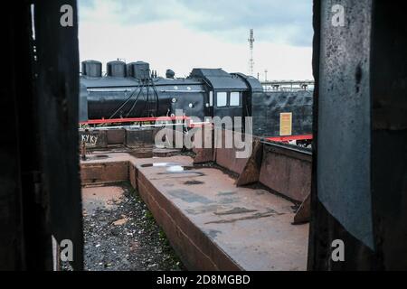Old Russian locomotive. Steam locomotive with red wheels. Retro locomotive on rails. Black locomotive with red star. Stock Photo