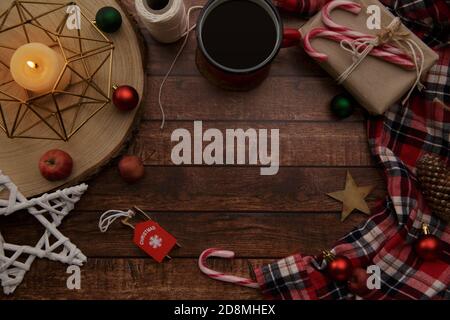 Christmas composition with candles, plaid shirt and caramel cane Stock Photo