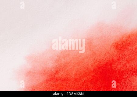 Trend photo on the theme of fashionable orange hue this season. Bright smear of watercolor paint on a white paper background. Stock Photo