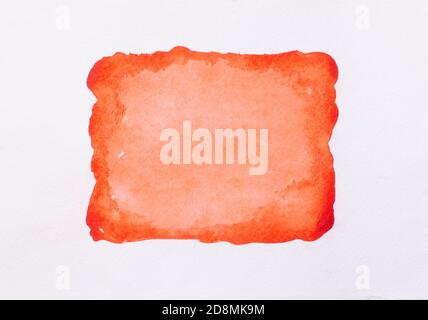 Trend photo on the theme of fashionable orange hue this season. Bright smear of watercolor paint on a white paper background. Stock Photo