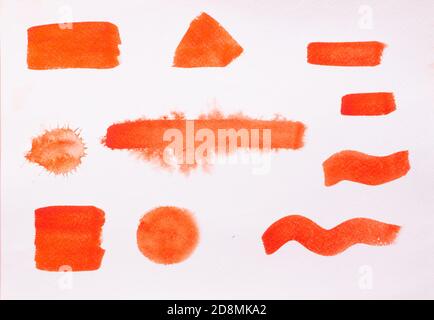 Trend photo on the theme of fashionable orange hue this season. Bright smear of watercolor paint on a white paper background. Stock Photo