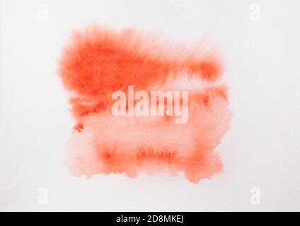 Trend photo on the theme of fashionable orange hue this season. Bright smear of watercolor paint on a white paper background. Stock Photo