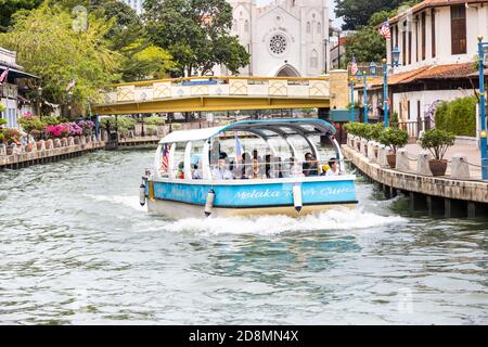 MALACCA, MALAYSIA, October 31, 2020: Melaka river cruise offer tourist a glimpse of historic city with historical buildings. Stock Photo