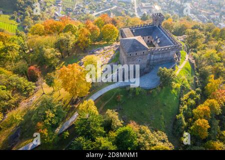 Aerial view of the medieval Bellinzona castles, Unesco World Heritage site, in autumn at sunset. Canton Ticino, Switzerland. Stock Photo