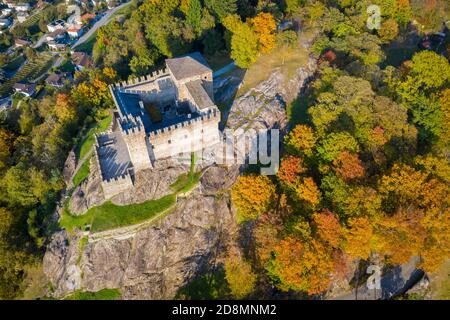 Aerial view of the medieval Bellinzona castles, Unesco World Heritage site, in autumn at sunset. Canton Ticino, Switzerland. Stock Photo