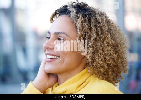 Close up side portrait of happy african american woman with curly hair Stock Photo