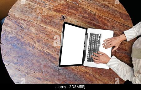 Businessman working on his laptop on textured round Rustic table view  from top Stock Photo