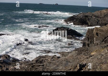 Waves breaking over rocks on North Cornish coast near Treyarnon Bay Stock Photo