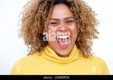 Close up horizontal portrait of young african american woman laughing against isolated white background Stock Photo