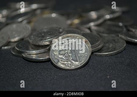 close up image of a pile of Philippine Peso coins under President Rodrigo Duterte's Presidential Management Stock Photo