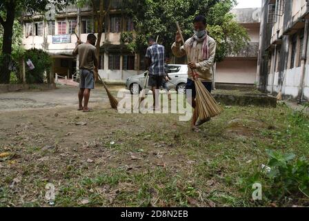 October 31, 2020, Guwahati, Assam, India: Indian workers clean the complex of  a government school ahead of its re opening from November 2 after a gap of 6 months due to coronavirus pandemics in Guwahati Assam India on Saturday 31st October 2020 (Credit Image: © Dasarath Deka/ZUMA Wire) Stock Photo