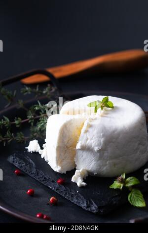 Local food concept organic fresh Goat cheese on black slate stone board background with copy space Stock Photo