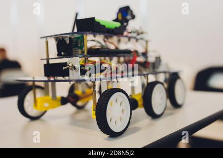 Homemade robot on wheels with eyes. Hobby robotics. Stock Photo