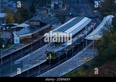 Commuters boarding a South Western Railway train in the dark of an early morning at Basingstoke train station, Hampshire, UK Stock Photo