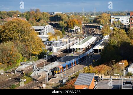 Aerial view during a sunny autumn day looking down on Basingstoke railway station and South Western Railway trains, Hampshire, UK Stock Photo