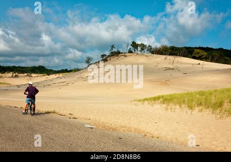 sand dunes, man on bicycle, vegetation, Warren Dunes State Park; Sawyer; MI; Michigan, summer; horizontal, MR Stock Photo