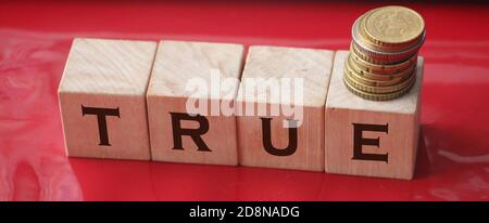 True word on wooden cubes on red. True or false facts, real and fake news concept Stock Photo