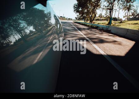 Car rushing along a high-speed highway in the sun Stock Photo - Alamy