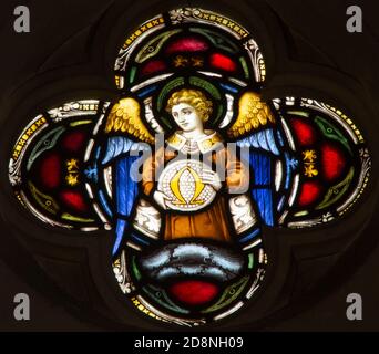 ROME, ITALY - MARCH 9. 2016: The angel with the symbolic Omega symbol on the stained glass rosette of All Saints' Anglican Church Stock Photo