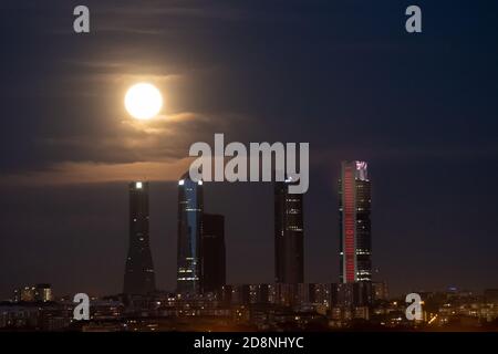 Madrid, Spain. 31st Oct, 2020. The full Blue Moon of October rising over Madrid skyline with the skyscrapers of the Four Towers Business Area. Credit: Marcos del Mazo/Alamy Live News Stock Photo