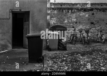 Garbage place in a backyard, garbage cans in a Berlin backyard, black and white photo Stock Photo