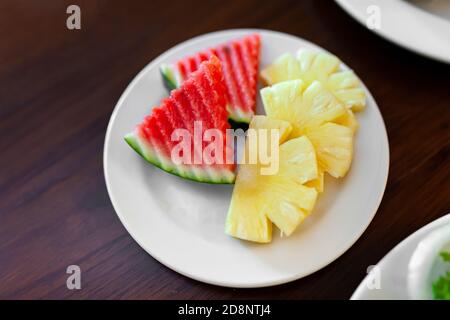 Fresh Watermelon and Pineapple slide in white dish. Stock Photo