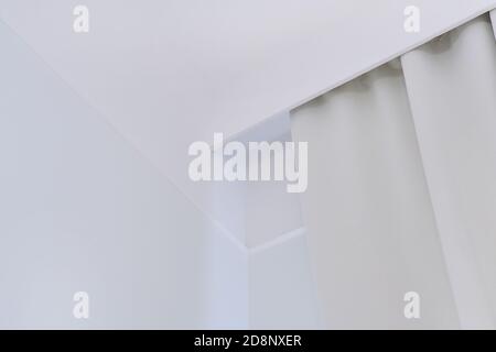 Interior details close up. White wall, ceiling, cornice niche, curtains on the window Stock Photo