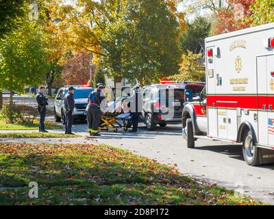 Oak Park, Illinois, USA. 31st October 2020. Paramedics move an automobile accident victim from his car to a waiting ambulance. Stock Photo