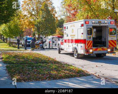 Oak Park, Illinois, USA. 31st October 2020. Paramedics move an automobile accident victim from his car to a waiting ambulance. Stock Photo