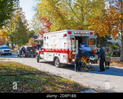 Oak Park, Illinois, USA. 31st October 2020. Paramedics load an automobile accident victim into an ambulance during COVID-19 pandemic. Stock Photo