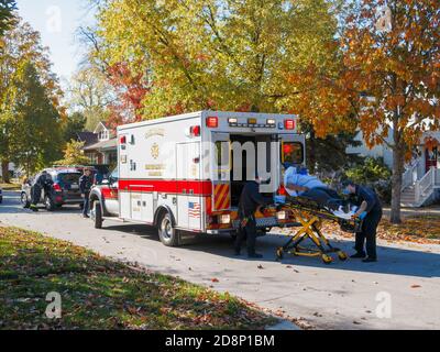 Oak Park, Illinois, USA. 31st October 2020. Paramedics load an automobile accident victim into an ambulance during COVID-19 pandemic. Stock Photo