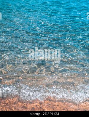 Turquoise Caribbean waves washing ashore the beach in St. Lucia Stock Photo
