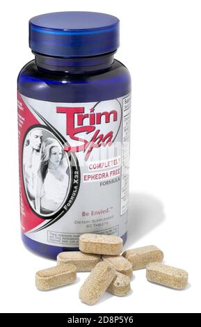 Bottle of trim spa diet pills photographed on a white background Stock Photo