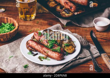 Baked Pork Sausages with Eggplant Slices Stock Photo