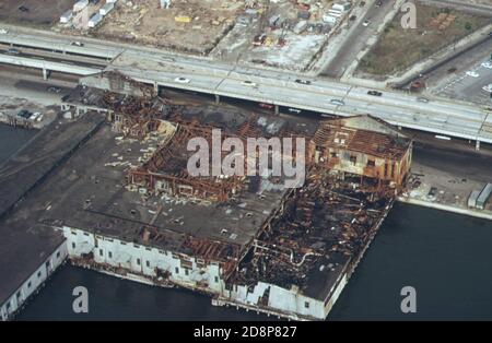 Disuse and age rot old warehouses and ship terminals on the Hudson River. Alongside is the West Side Highway; a major Manhattan traffic artery  ca. 1973 Stock Photo