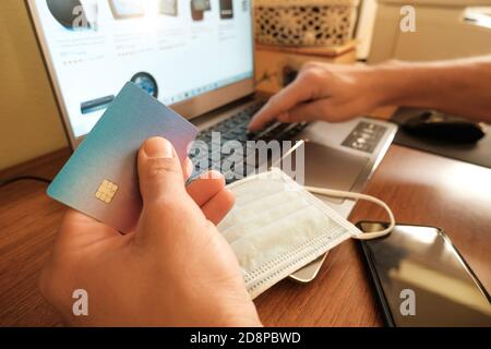 Rome,italy - october 30 2020: Man use visa credit card for web payment on laptop,tech e-commerce business Stock Photo