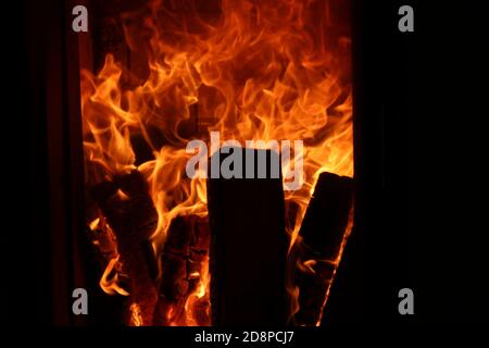 Fire in fireplace or oven on high shutter speed, close up from hot orange Flame in winter Stock Photo
