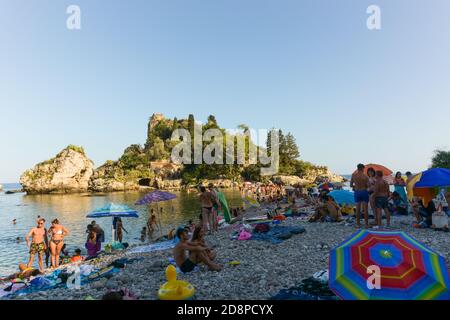 TAORMINA, ITALY - Aug 29, 2020: Taormina, Sicily, south Italy - August 27 2020 -  Crowded beach in taormina next to the famus Isola Bella in the backg Stock Photo