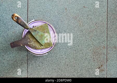 Putty knife with tub of paste for wood and metal Stock Photo