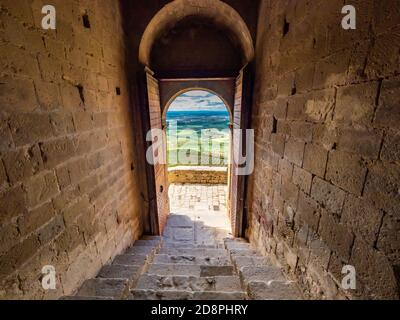 Amazing shot of a stone made historic building door opening with a picturesque landscape view Stock Photo
